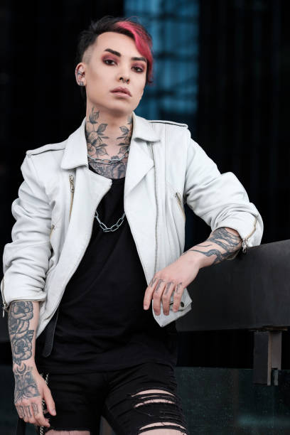 istock Confident portrait of androgynous non-binary male looking at camera outdoors. 1490764443