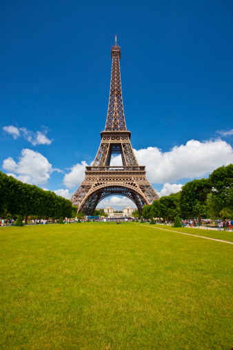 Eiffel Tower on a sunny spring day, as seen from the Champ de Mars, Paris, France.  The Eiffel Tower is the most recognized travel landmark in the world.