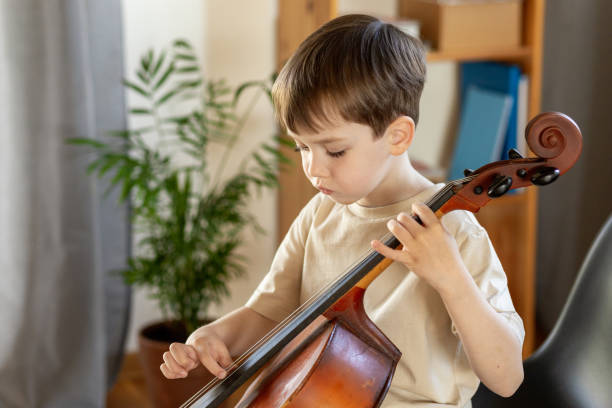 istock White 5 year old boy learning to play the cello 1490764862