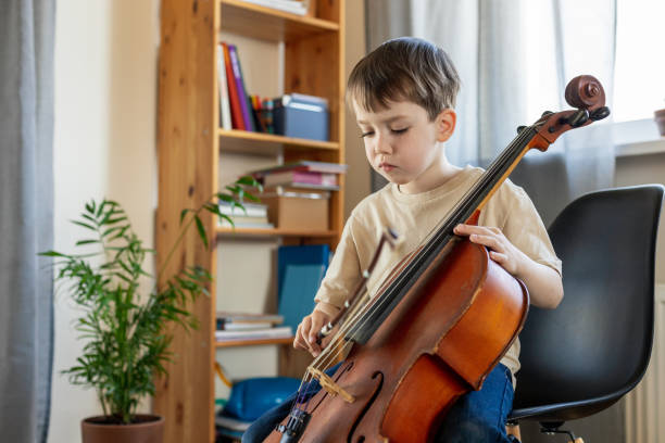 istock White 5 year old boy learning to play the cello 1490764898