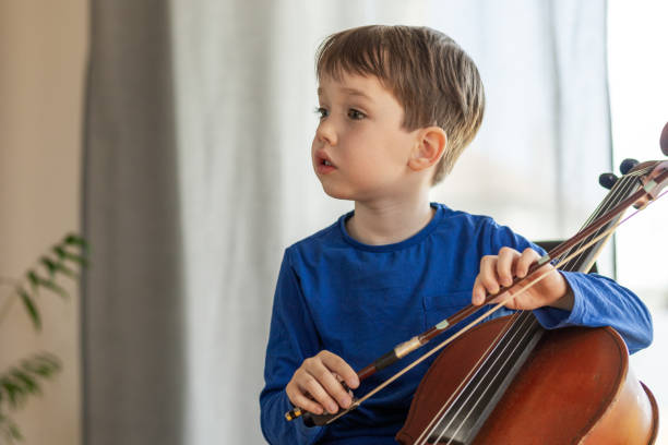 istock White 5 year old boy learning to play the cello 1490764900