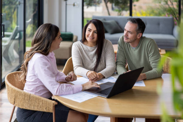 Financial advisor talking to a couple at their house