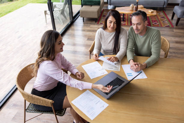 istock Financial advisor talking to a couple about their home finances 1490765052