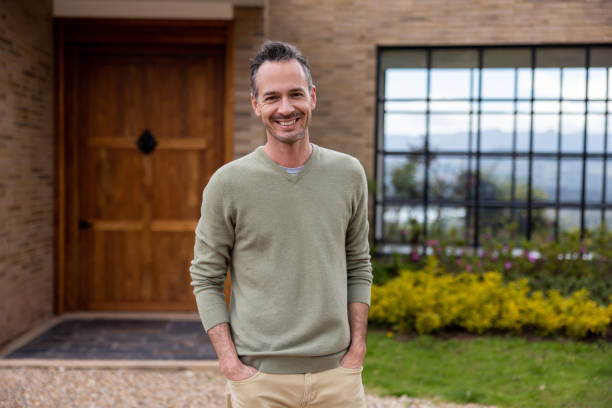 istock Happy man smiling outside his new house 1490765657