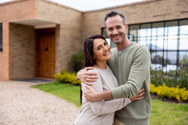 istock Happy couple smiling outside their new house 1490765721