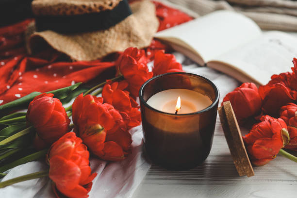 istock Cozy spring composition, burning candle, peonies and hat 1490766804