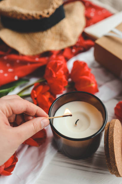 istock Match in hand lights a candle, atmospheric photo 1490766826