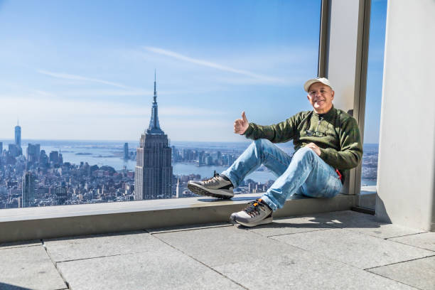 Middle aged man sitting at the window with beautiful view