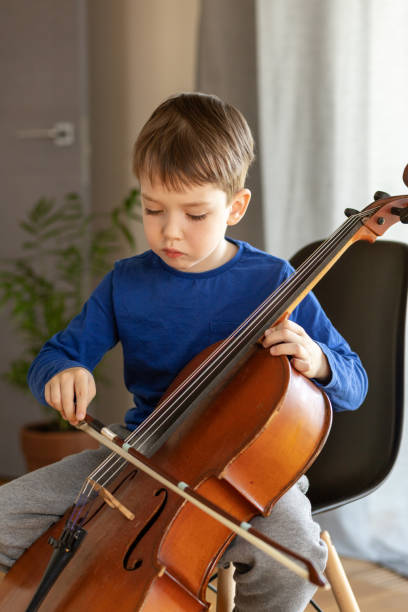 istock White 5 year old boy learning to play the cello 1490767215