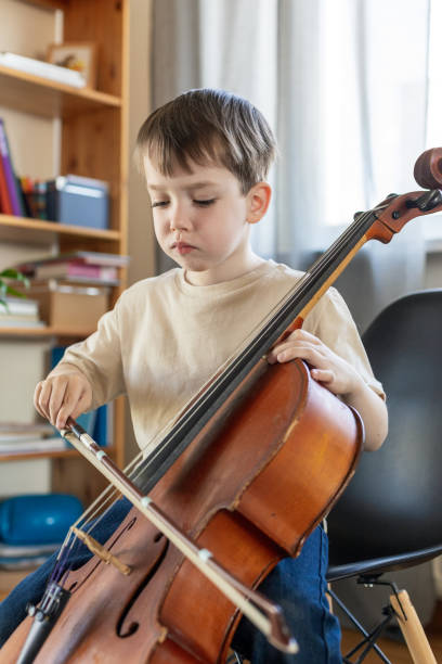 istock White 5 year old boy learning to play the cello 1490767224