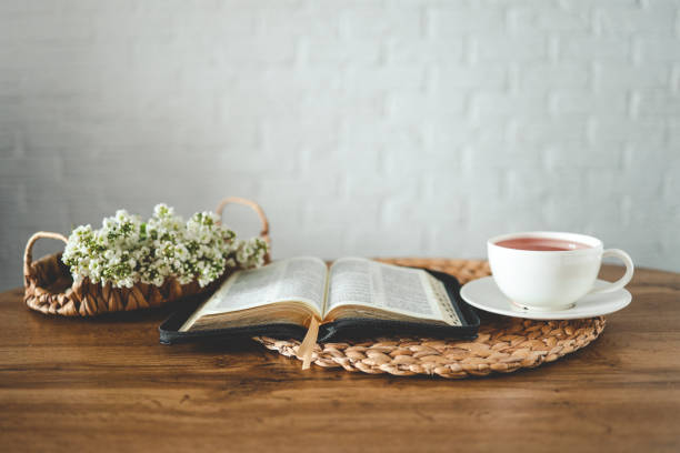 istock Open bible, flowers and a cup of tea, space for text 1490767279