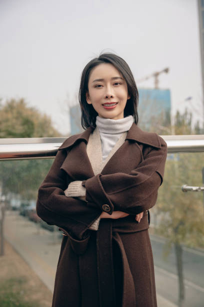istock Attractive woman in city with arms folded 1490767855