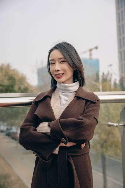 istock Attractive woman in city with arms folded 1490768319