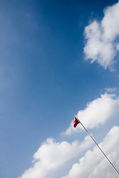 Red flag and blue sky stock photo