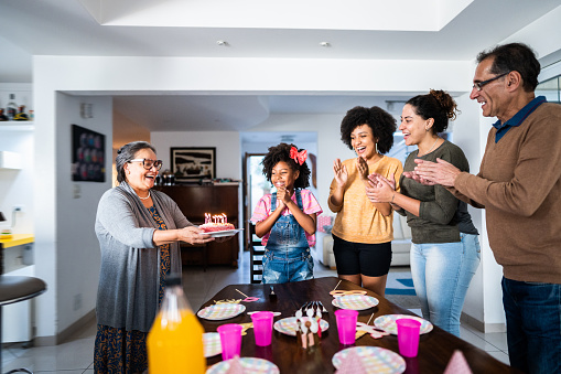 Girl child celebrating her birthday with lesbian family at home