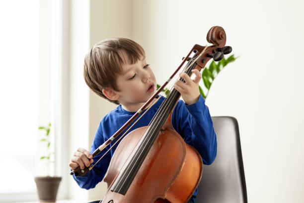 istock White 5 year old boy learning to play the cello 1490770544