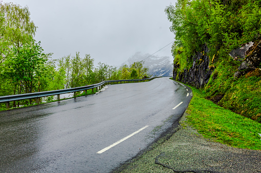 Green hill by the road.