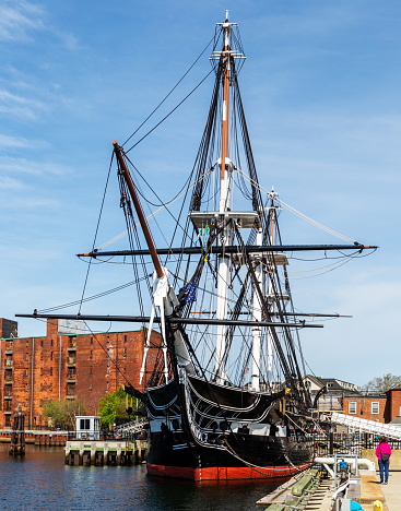 Boston, Massachusetts, USA - May 14, 2023: USS Constitution, also known as Old Ironsides, is a three-masted wooden-hulled heavy frigate of the United States Navy. She is the world's oldest ship still afloat. She was launched in 1797, one of six original frigates authorized for construction by the Naval Act of 1794. Constitution is most noted for her actions during the War of 1812 against the United Kingdom, when she captured numerous merchant ships and defeated five smaller British warships. Constitution was retired from active service in 1881 and served as a receiving ship until being designated a museum ship in 1907.