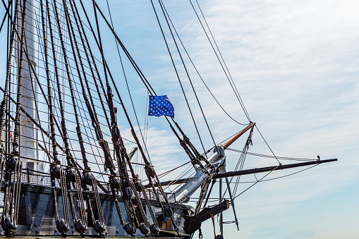 Boston, Massachusetts, USA - May 14, 2023: View of bowsprit of USS Constitution, also known as Old Ironsides. The ship is a three-masted wooden-hulled heavy frigate of the United States Navy. She is the world's oldest ship still afloat. She was launched in 1797, one of six original frigates authorized for construction by the Naval Act of 1794. Constitution is most noted for her actions during the War of 1812 against the United Kingdom, when she captured numerous merchant ships and defeated five smaller British warships. Constitution was retired from active service in 1881 and served as a receiving ship until being designated a museum ship in 1907.