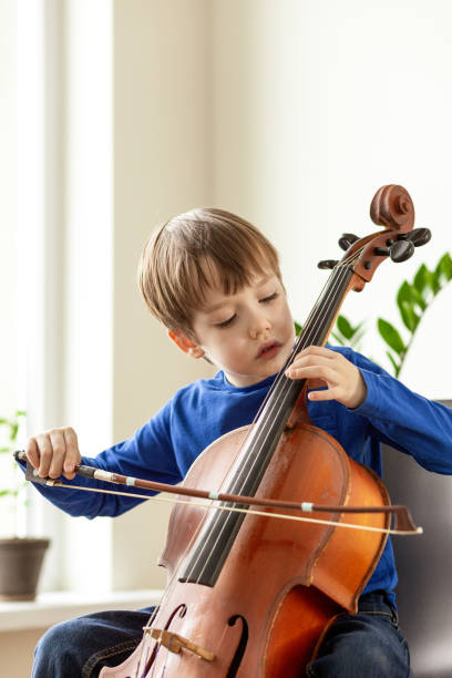 istock White 5 year old boy learning to play the cello 1490774469