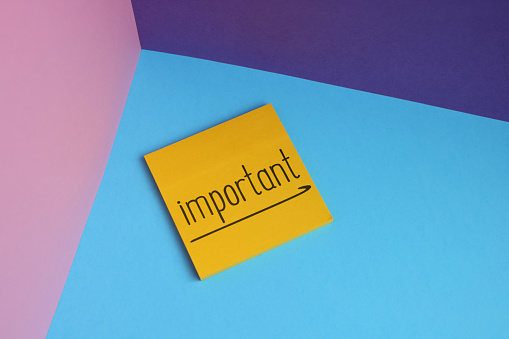 The word of important on adhesive note paper