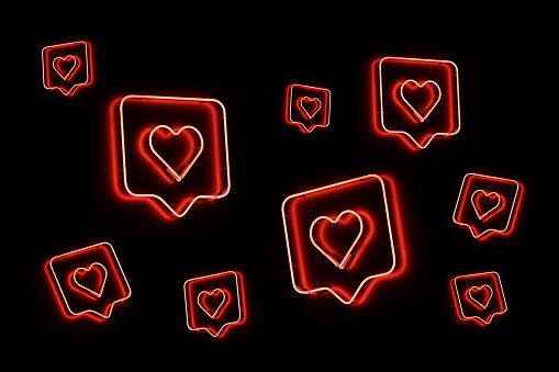 Neon heart shapes on black background