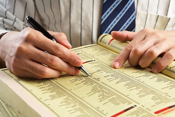 istock Businessman searching in yellow pages 149077933