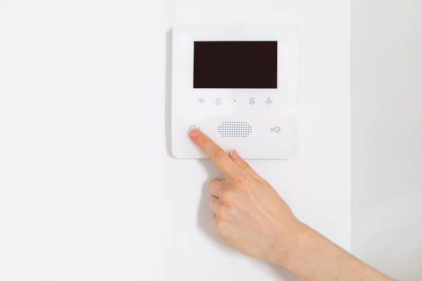 istock Woman hand presses on button of modern intercom 1490781569