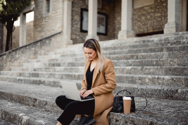 istock young woman working outdoors remotely. 1490781660
