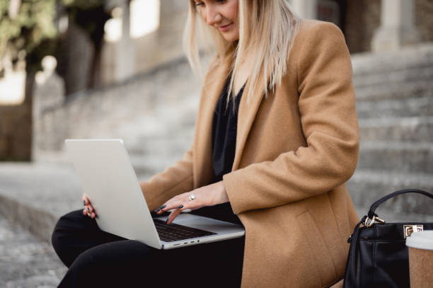 istock midsection of a female working on computer outdoors. 1490781728