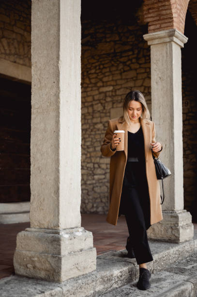 istock young woman walking down the stairs. 1490781868