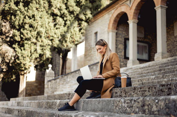 istock young woman learning on remote location outdoors. Distance education concept. 1490781911