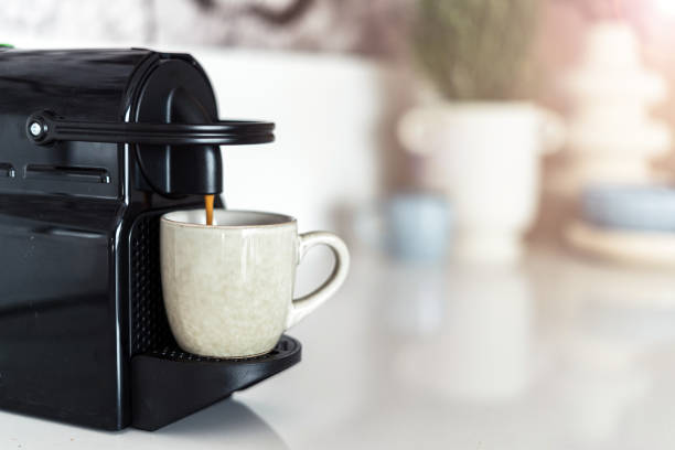 istock Modern coffee machine filling a ceramic cup with espresso 1490782043