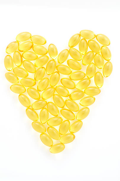 Heart made out of fish oil supplements stock photo