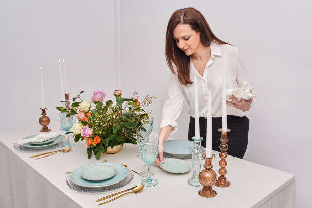 istock Beautiful woman laying table in kitchen at home 1490782656