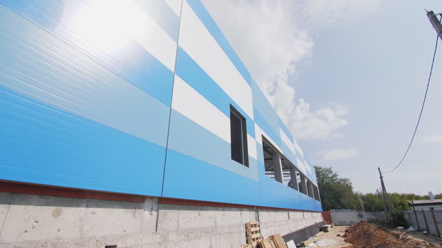 Building facade covered with panels at construction sit