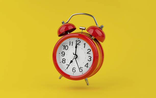 istock Red alarm clock hangs in the air on yellow background 1490785280