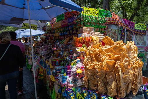 Mexico City, Mexico, May 07, 2023: A stall inside Chapultepec Park entices visitors with an array of assorted chips and chicharron, offering a savory and flavorful snack experience amidst the park's natural beauty. High quality photo