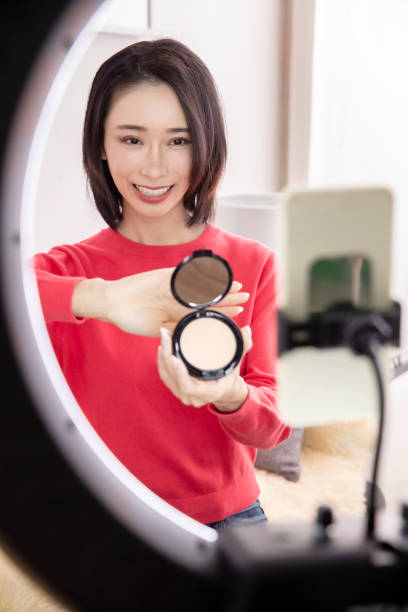 istock Young Asian woman live streaming to teaching make up online 1490785751