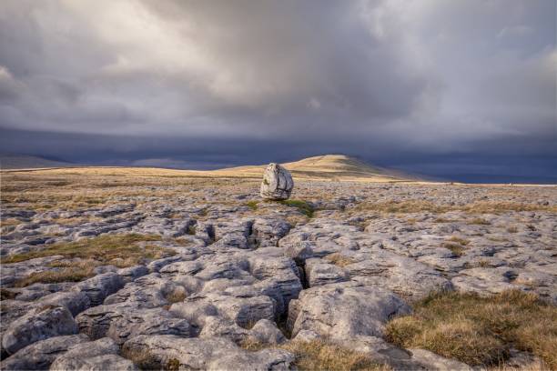 Glacial erratic boulders on Twistleton Scar. Yorkshire Dales National Park, Glacial erratic boulders on Twistleton Scar. Yorkshire Dales National Park in spring time. ingleborough stock pictures, royalty-free photos & images