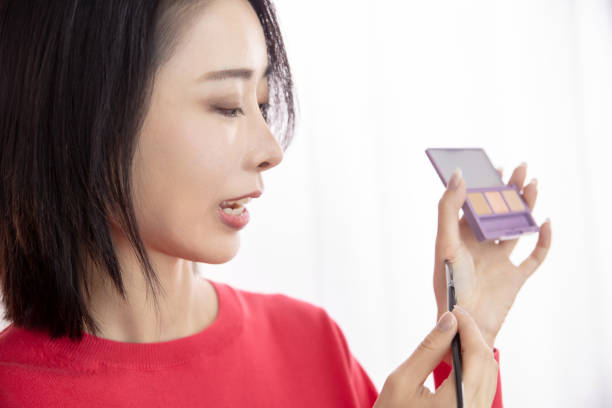 istock Young Asian woman live streaming to teaching make up online 1490787565