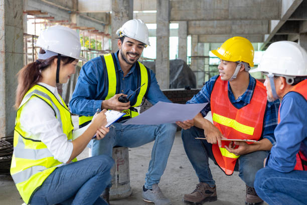 team of engineer, architect, contractor and foreman meeting and consulting at the construction building site with floor plan for real estate development project industry and housing timeline usage - subcontractor imagens e fotografias de stock