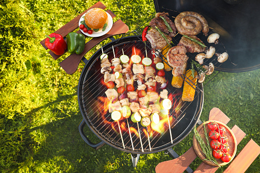 Cooking meat and vegetables on barbecue grill outdoors, flat lay