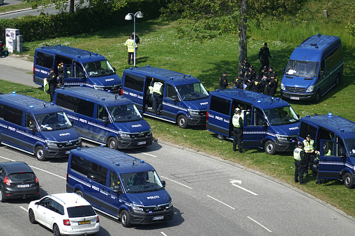 Danish policeofficers and policevans outside Brondby Stadium before a highrisk derbymatch between Brondby IF and FC Copenhagen in Brondby, Copenhagen on a sunny day in Denmark