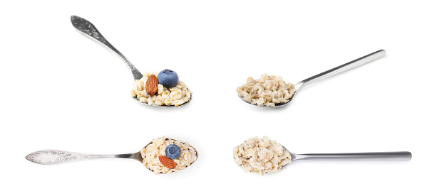 Set of spoons with tasty oatmeal porridge on white background. Banner design