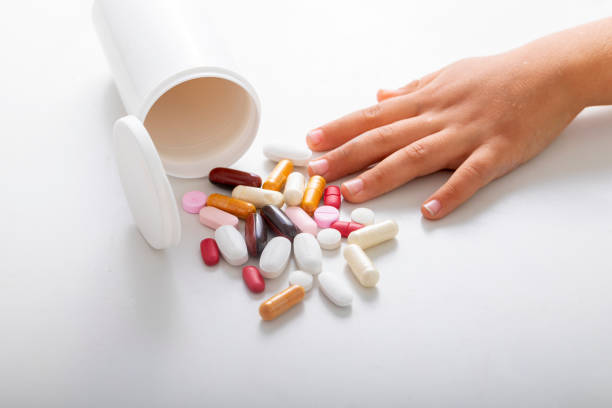 istock child hand with medicine pills 1490797771