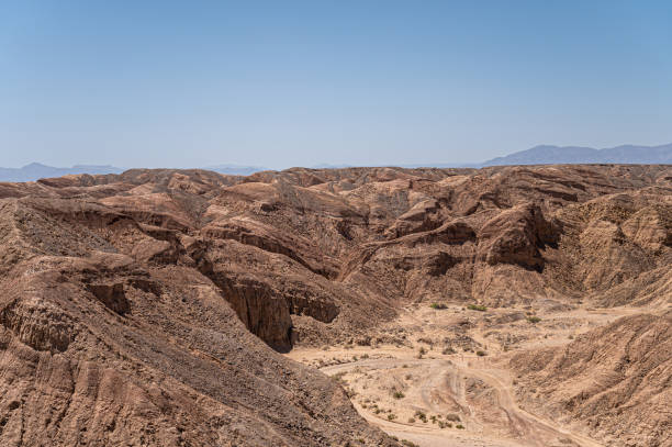 Borrego Springs, CA, USA - April 24, 2023: Ocotillo Wells viewpoint along Borrego Salton Sea Way or S22 shows sandy trails on rough rocky landscape under blue sky