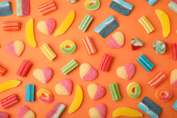 istock Many different jelly candies on orange background, flat lay 1490798104