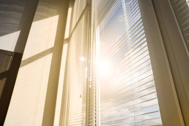 istock Stylish window with horizontal blinds in room, low angle view 1490803470