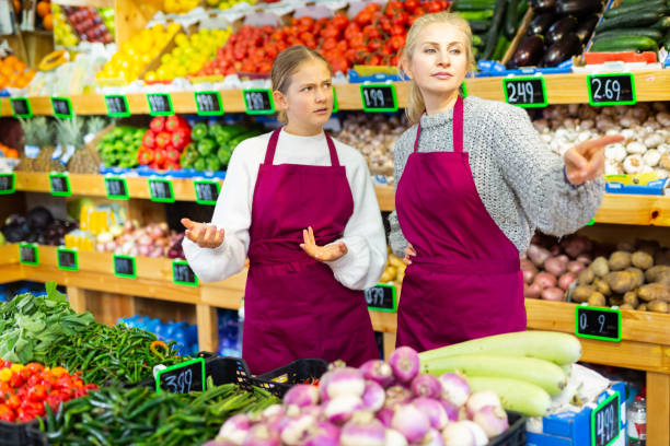 istock Grocery store employee points hand to young trainee girl 1490803863